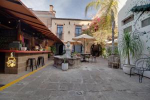 a patio with a bar and tables and chairs at Hotel Punto 79 in San Miguel de Allende +70 photos