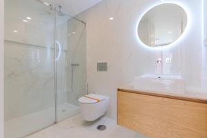 a bathroom with a shower and a toilet and a sink at D'AUSE - New Modern Apt - 150m to Beach & Center in Esposende