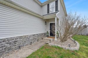 a house with a window and a tree in front of it at Spacious King Suite, Game Room, Patio, Firepit in Lexington