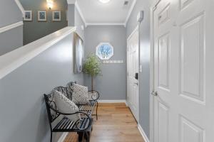 a hallway with a white door and a black chair at Spacious King Suite, Game Room, Patio, Firepit in Lexington +53 photos