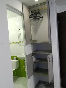 a bathroom with a sink and a toilet and a mirror at Van Gogh Duitama in Duitama