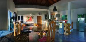 a living room with a table and a kitchen at I VIEW - in Long Bay in Long Bay Village