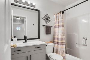 a bathroom with a sink and a toilet and a mirror at Spacious King Suite, Horses, Fire Pit, Garage in Lexington +29 photos