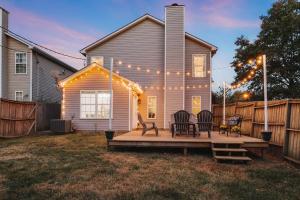 a house with a deck with chairs and lights at Spacious King Suite, Horses, Fire Pit, Garage in Lexington