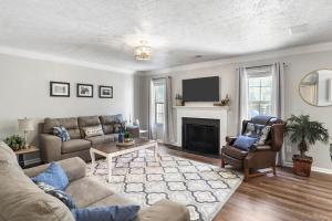 a living room with a couch and a fireplace at Spacious King Suite, Horses, Fire Pit, Garage in Lexington