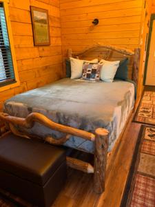a bedroom with a bed in a log cabin at Sockeye Cabin - Best Views & Fishing in Seward