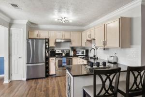 a kitchen with stainless steel appliances and wooden cabinets at Spacious King Suite, Horses, Fire Pit, Garage in Lexington