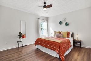 a white bedroom with a bed and a ceiling fan at Spacious King Suite, Horses, Fire Pit, Garage in Lexington