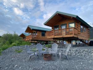 a cabin with a table and chairs in front of it at Sockeye Cabin - Best Views & Fishing in Seward