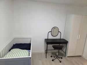 a bedroom with a bed and a desk and a mirror at 2 room apartment in Horsens in Horsens