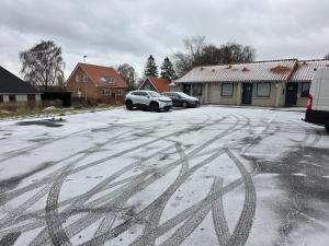 a snow covered parking lot with cars parked in it at 2 room apartment in Horsens in Horsens