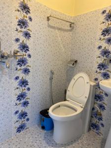 a bathroom with a toilet and a sink at Beli Guest House in Pokhara +118 photos