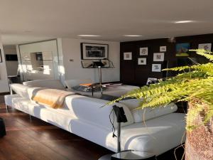 a living room with a large white couch at The Sweet Escape Premium villa with pool in Theux