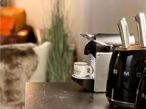 a coffee maker and a toaster sitting on a table at The Jade Elegant apartment with balcony in Spa