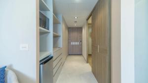 a hallway leading to a bedroom with a closet at Beachfront Luxury Studio in Puerto Peñasco