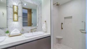 a white bathroom with a sink and a mirror at Beachfront Luxury Studio in Puerto Peñasco +4 photos