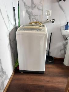 a washing machine sitting on the floor in a bathroom at Villa Lagunitas in Puerto Montt