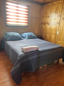 a large bed in a room with a window at Villa Lagunitas in Puerto Montt