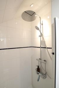 a shower in a white tiled bathroom at Les Cimes - Le Tholy in Le Tholy +28 photos