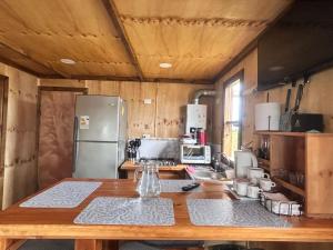a kitchen with a wooden counter top with a refrigerator at Villa Lagunitas in Puerto Montt