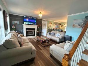 a living room with a couch and a fireplace at Lake House in Phil Campbell