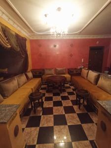 a living room with a couch and a checkered floor at Tetuan in Tétouan