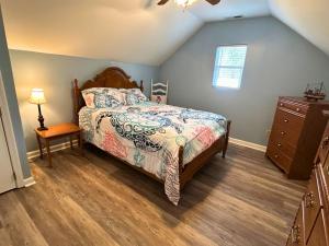 a bedroom with a bed and a dresser at Lake House in Phil Campbell