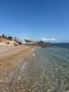 a beach with a rocky shoreline and the ocean at CHALET directo al MAR in Benicarló