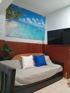 a bed with two blue pillows in a room at Mistela Altos Crucero Boutique - Alojamiento temático - Zona Residencial Ciudad - Viajes al Aeropuerto - in Godoy Cruz