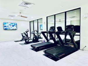 a gym with treadmills and elliptical machines at Shoreline Studio Condo for 4 in Galveston