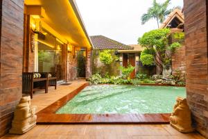 a swimming pool in the yard of a house at Sajjana House Nusadua By Magno in Nusa Dua