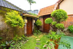 an outside view of a house with a yard at Sajjana House Nusadua By Magno in Nusa Dua