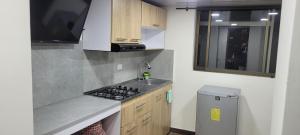 a small kitchen with a sink and a stove at Apto con balcon in Pasto