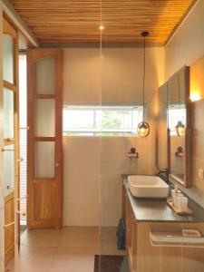 a bathroom with a sink and a mirror at The Sawa Stay in Jarakan +51 photos