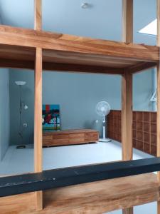 a view from the top of a room with wooden beams at The Sawa Stay in Jarakan
