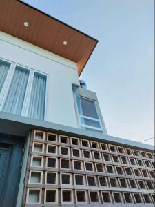 a white house with windows on the side of it at The Sawa Stay in Jarakan