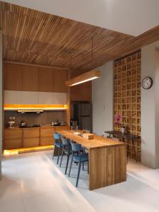a kitchen with a large wooden table and chairs at The Sawa Stay in Jarakan