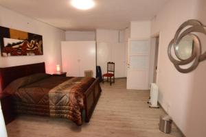 a bedroom with a bed and a table and a chair at Room 2 - Music House in Bicas
