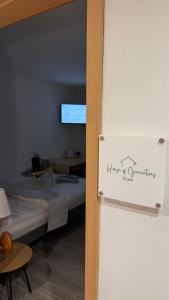 a room with a bed with a sign on the door at Zentrale Gästezimmer am Marienplatz- Paris in Stuttgart +2 photos