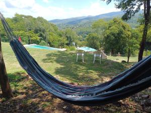a hammock in a field with a pool at Wandritu in Río Ceballos