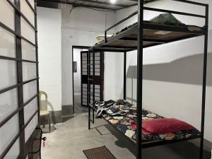 a room with two bunk beds in a room at Pushpa Nilayam in Khaprail