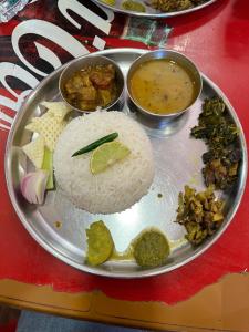 a plate of food with rice and vegetables on a table at Pushpa Nilayam in Khaprail
