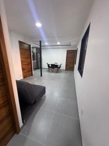 a living room with a couch and a table at Modernos Departamentos Centricos in Ciudad Guzmán