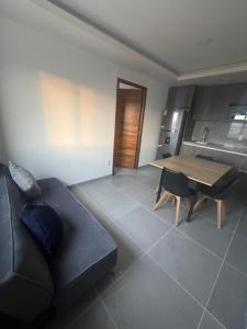 a living room with a black couch and a wooden table at Modernos Departamentos Centricos in Ciudad Guzmán
