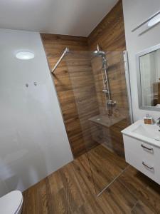 a bathroom with a shower and a toilet and a sink at Apartament Podmiejska Nova in Kalisz +49 photos