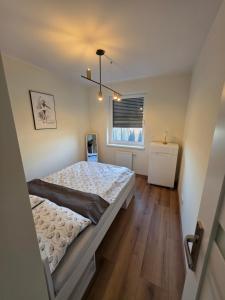 a bedroom with a large bed and a window at Apartament Podmiejska Nova in Kalisz