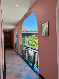a hallway with an arched window and a balcony at DEE Homestay in Hue