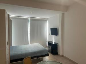 a bedroom with a bed and a window at Las Piedras in Pilar