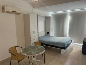 a small bedroom with a bed and a table and a tableablish at Las Piedras in Pilar +19 photos