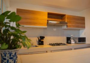 a kitchen with a sink and a stove top oven at Viveros Centric and Comfortable Apt 2BR B Quintana Alamos in Laborcillas